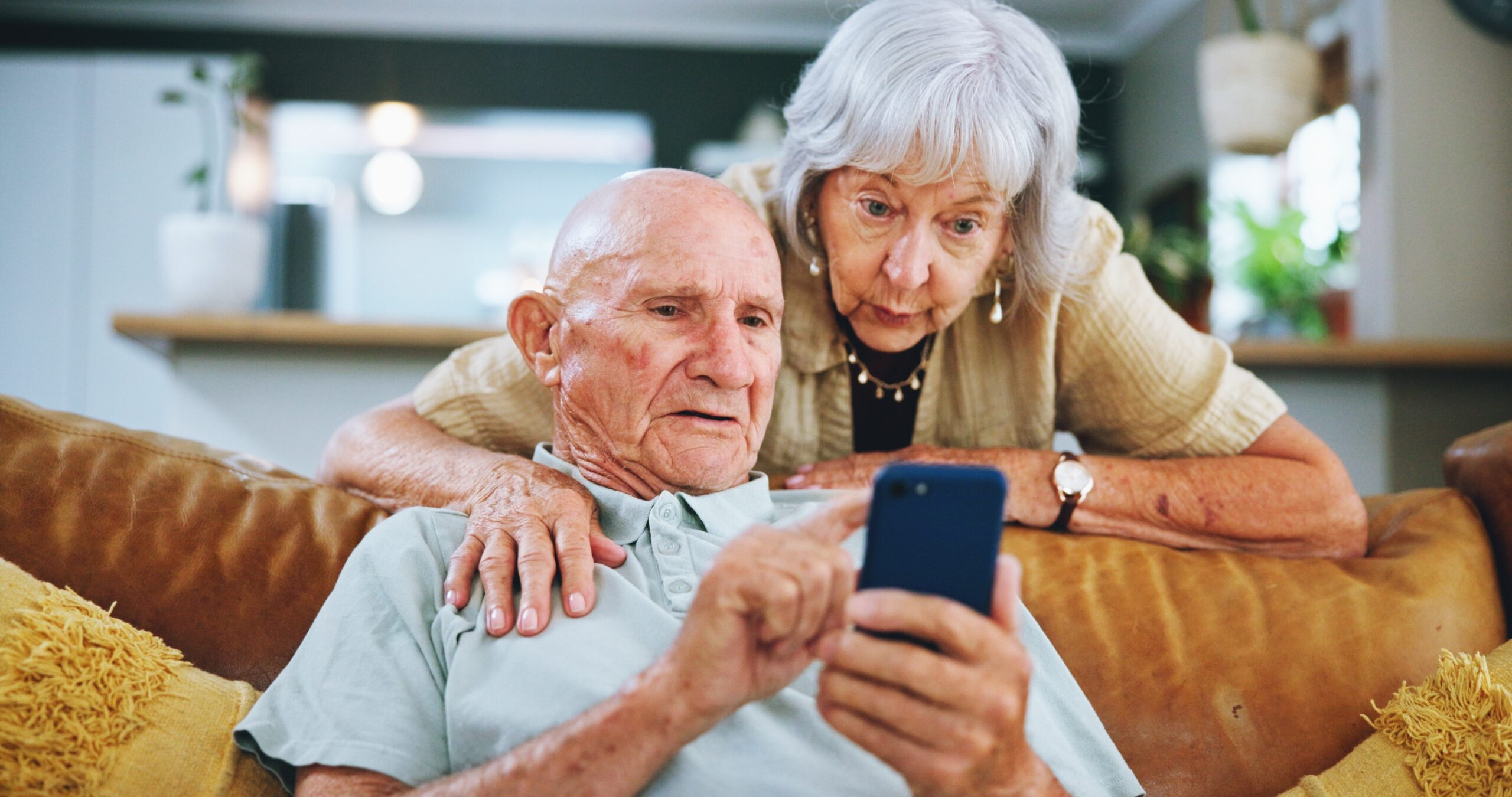 Senior,Couple,,Phone,And,Search,On,Couch,For,Hug,,Choice